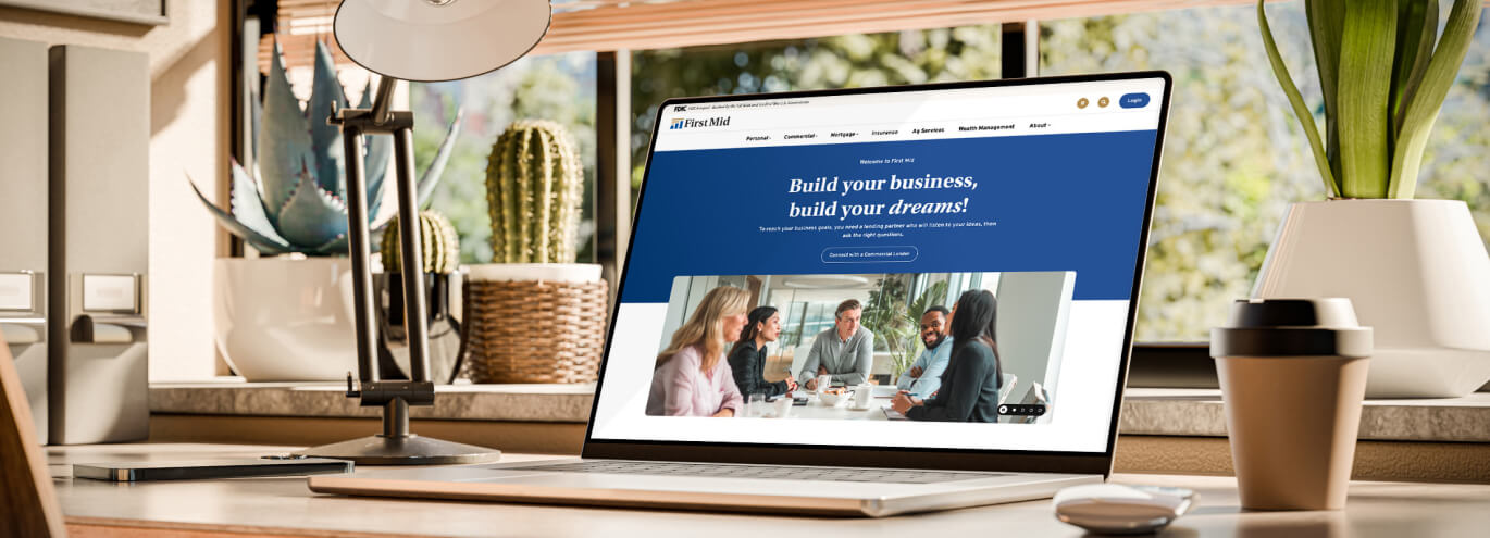 desk with laptop displaying new FMB&T website