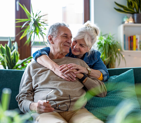 mature couple embracing in living room