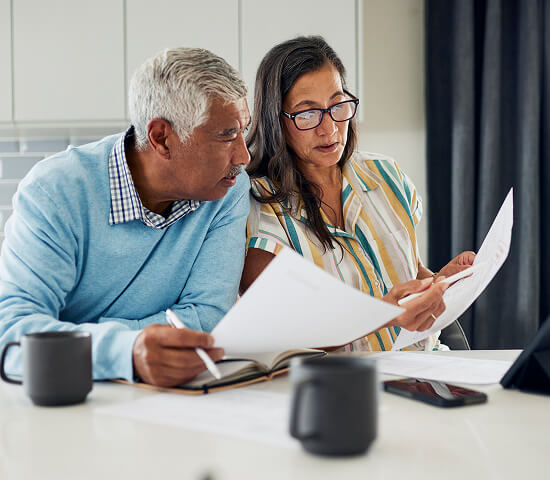 couple reviewing documents in kitchen