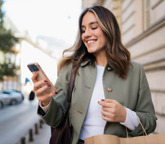 woman with shopping bags and mobile phone