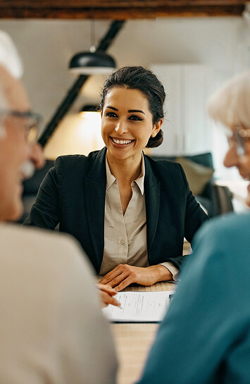 mature couple in meeting with smiling woman