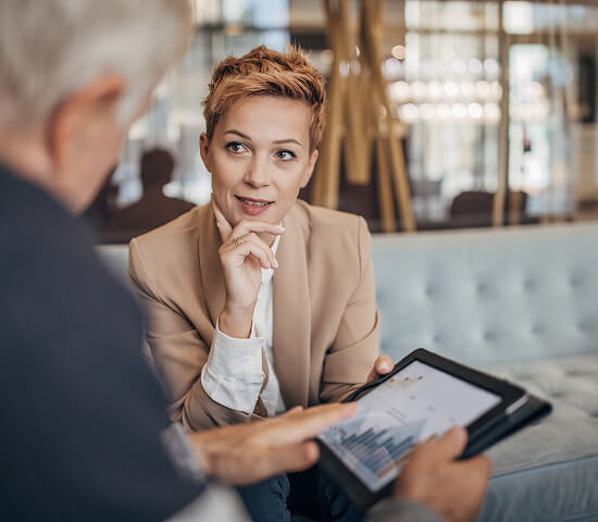 two business people looking at bar graph